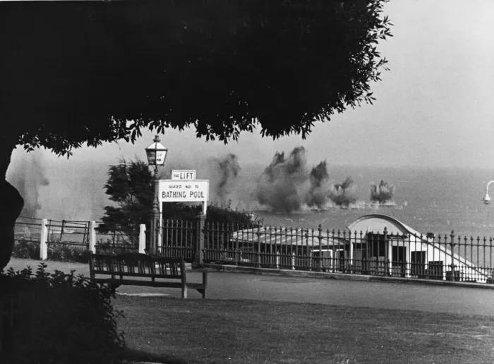 Framed Print : A salvo of bombs dropping into the sea off a South East coast town during Second World