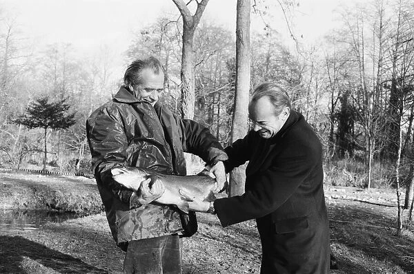 Sam Holland (left), trout farmer with James Pettigrew, hold some of the outsize trout at