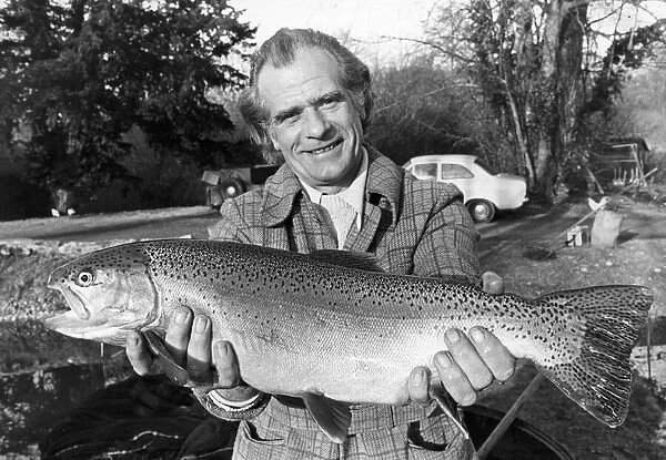 Sam Holland proudly holding one of his specially bread super trouts at his fishery at