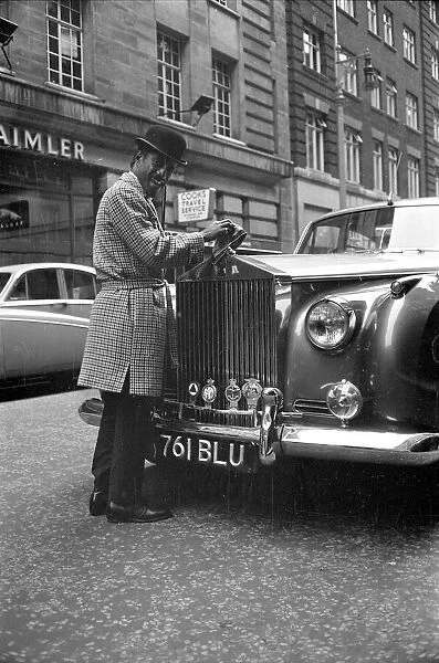 Sammy Davis Jnr. in London polishing his new Rolls Royce. 31st March 1963