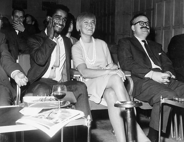 Sammy Davis Jnr with his wife, actress May Britt, watching an extract of his new film