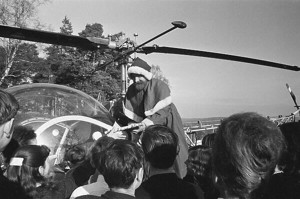 Santa Claus arrives by helicopter at Pestalozzi Village for Children in Sedlescombe