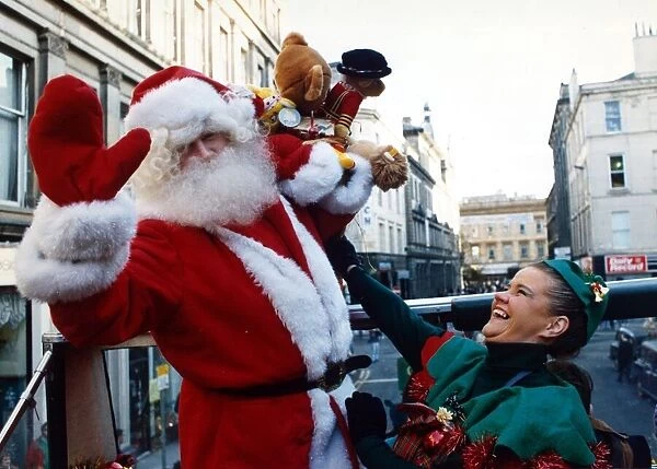 Santa Claus with one of his little elf helpers pictured in Glasgow December 1991