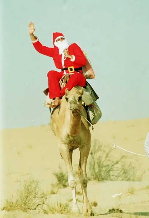 Framed Print : Santa Claus riding a camel holding sack