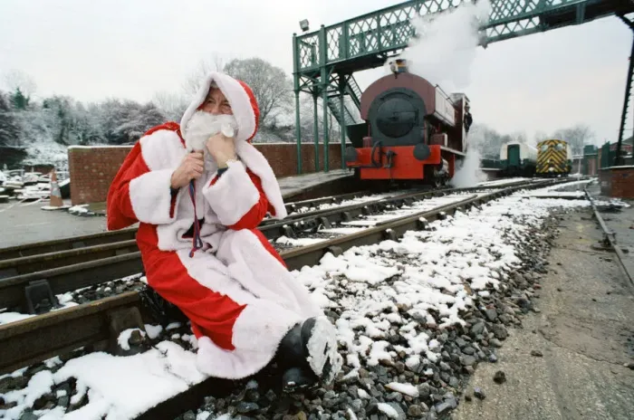 Framed Print : Santa stopped in his tracks. Father Christmas sitting on railway tracks Framed Print : Santa stopped in his tracks. Father Christmas sitting on railway tracks
