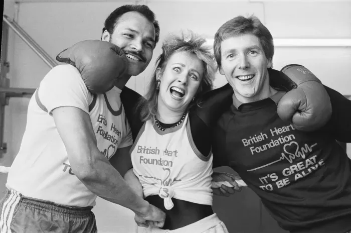 Framed Print : Saturday presenter Sarah Green, helped put John Conteh (left Framed Print : Saturday presenter Sarah Green, helped put John Conteh (left