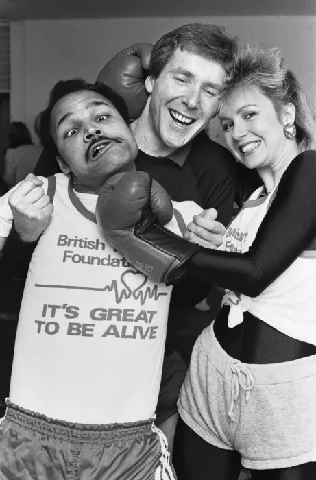 Framed Print : Saturday presenter Sarah Green, helped put John Conteh (left