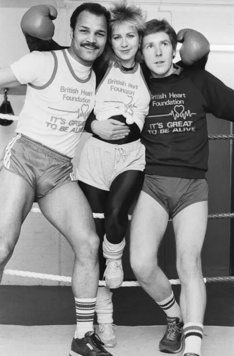 Framed Print : Saturday presenter Sarah Green, helped put John Conteh (left