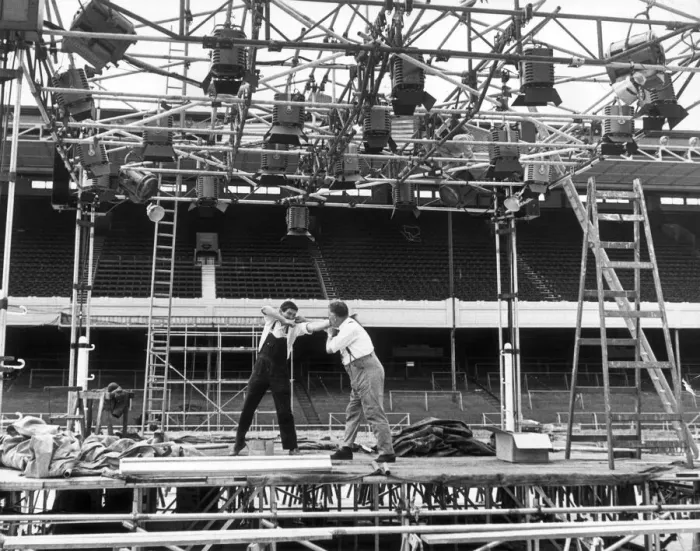 Framed Print : Scaffolders at Highbury having a quick round during their lunch break Framed Print : Scaffolders at Highbury having a quick round during their lunch break