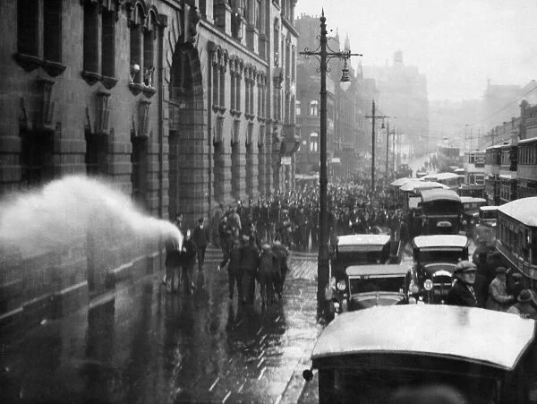 A scene of chaos and confusion as firemen turn the hose on a demonstration of unemployed