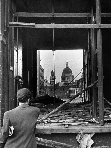 A scene in Fetter Lane, looking through shattered shop window across the blitzed site to