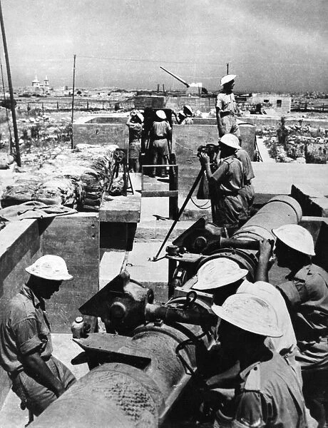 A Scene in Malta as heavy guns of an anti aircraft battery open fire on raiding enemy