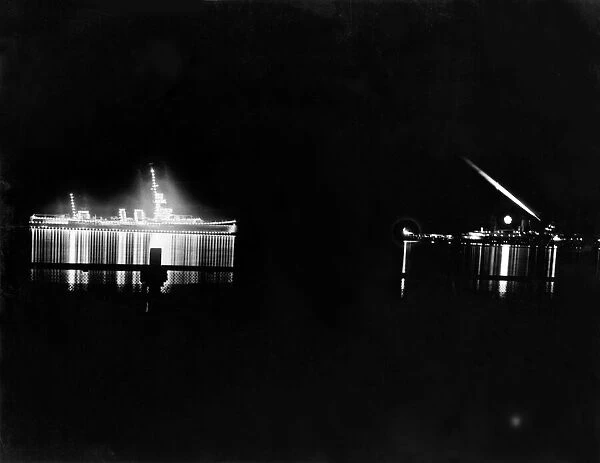 The scene by night at Kingston Harbour, Jamaica, showing Cruiser Colombo, on left