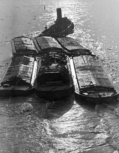 A scene showing barges on the River Thames 20th December 1937