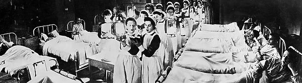 Scene at Westminister Hospital on Christmas Eve - 1940 Nurses walk through wards