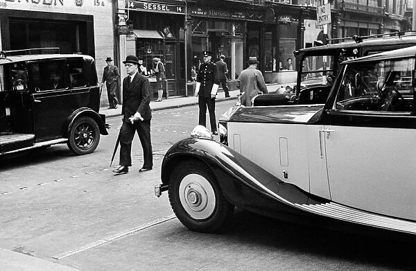 Scenes in Bond Street, Central London with man wearing bowler hat