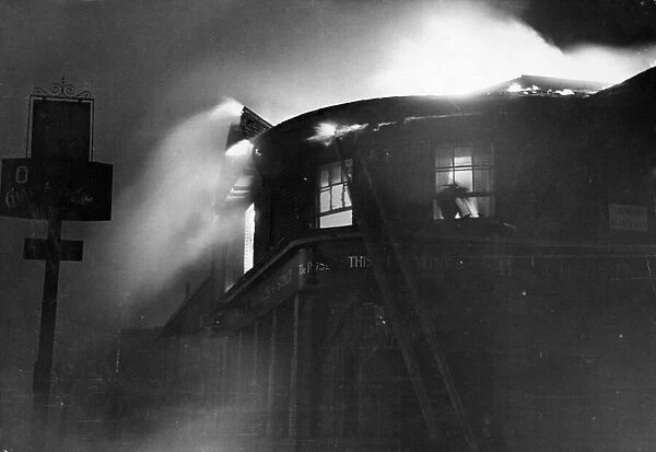 Scenes during the London blitz. A building on fire on Lowth Road, London. Circa 1940