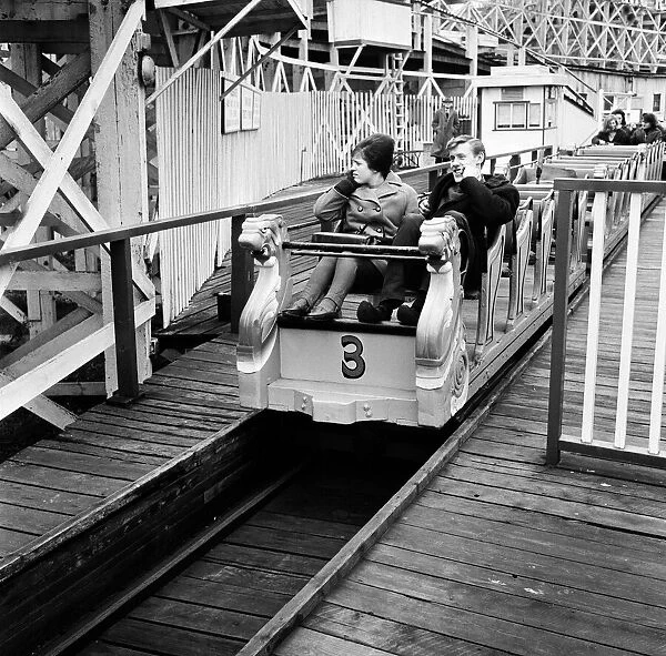 Scenes in Margate, Kent, during Good Friday. A couple on a funfair ride. 27th March 1964