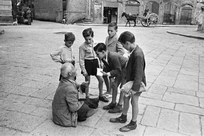 Framed Print : Scenes in Naples, southern Italy showing young boys talk to a beggar in the city streets Framed Print : Scenes in Naples, southern Italy showing young boys talk to a beggar in the city streets