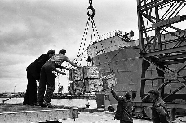 Scenes at Swansea Docks, Wales. Loading steel for Poona, via Bombay, are Gwilym Williams