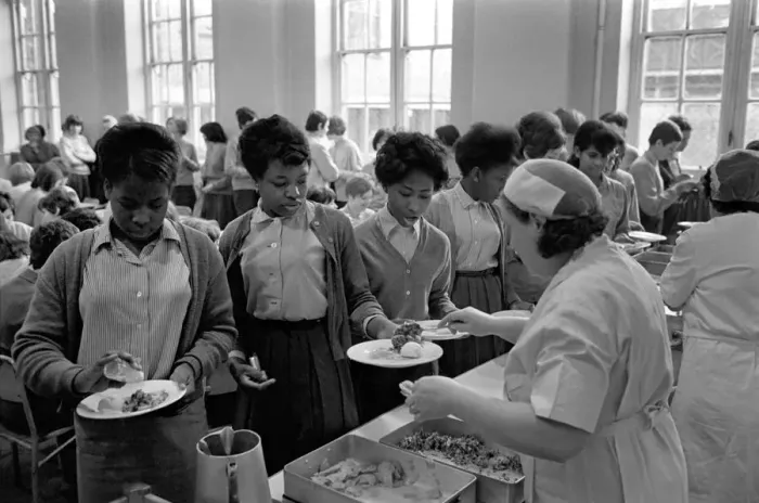 Framed Print : School Dinners. General scenes of school dinner. Ladies serving meal to pupils in Framed Print : School Dinners. General scenes of school dinner. Ladies serving meal to pupils in