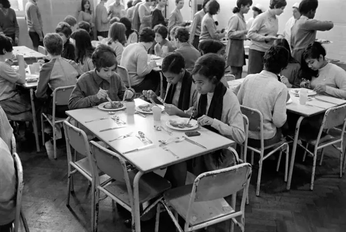 Framed Print : School Dinners. General scenes of school dinner. Ladies serving meal to pupils in