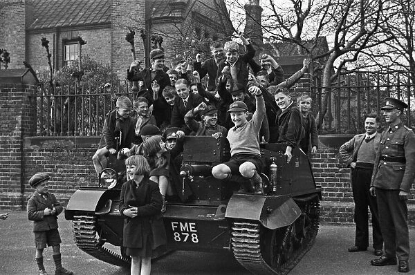 Schoolchildren clamber over a Bren Gun Carrier of the 2nd Battalion East Surrey Regiment
