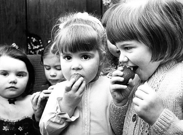 Some schoolchildren eating mini Easter eggs in 1975
