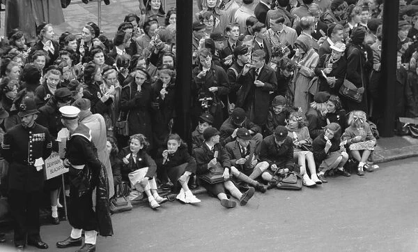 Schoolchildren enjoy a ice lolly on Victoria Embankment whilst waiting for the Royal