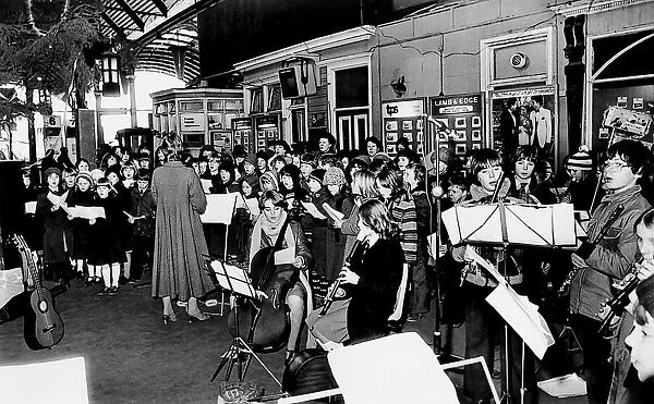 These schoolchildren get into the festive mood carol singng at a Tyneside railway station