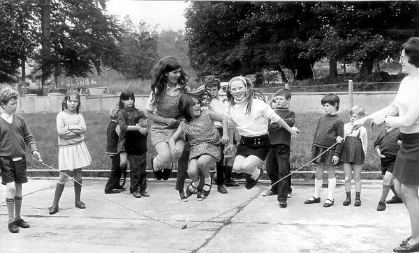 Schoolchildren skipping in the playground. 10th October 1971