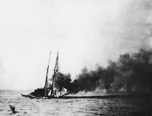 A schooner set on fire by the crew of a German U-Boat. Circa September 1918