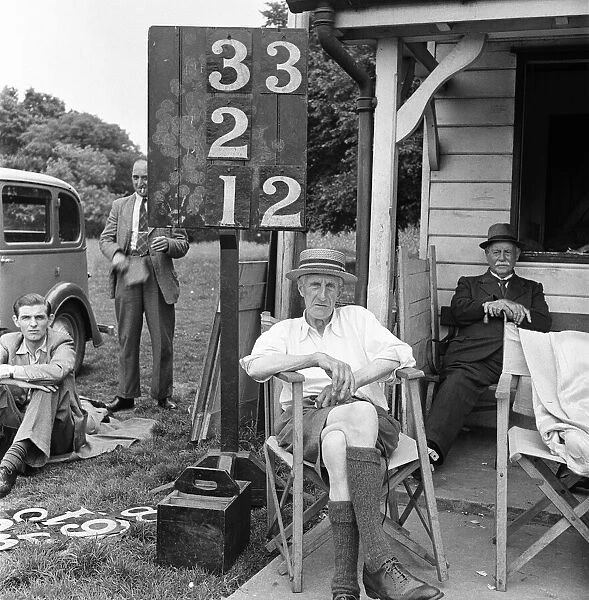 Scorer beside the scoreboard at the cricket pavilion, Meopham home to one of the oldest