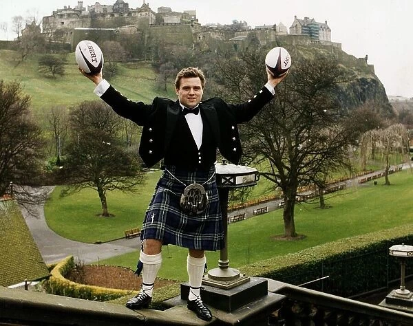 Scotland and Bath Rugby Union player David Hilton wearing kilt standing on wall holding