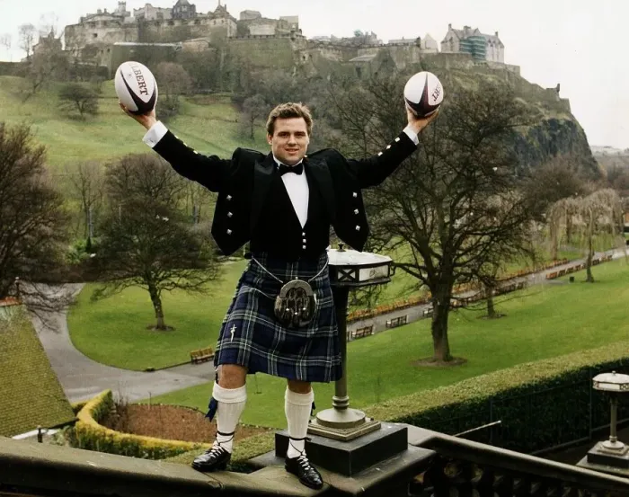 Framed Print : Scotland and Bath Rugby Union player David Hilton wearing kilt standing on wall holding Framed Print : Scotland and Bath Rugby Union player David Hilton wearing kilt standing on wall holding