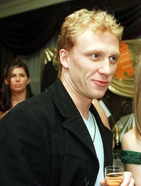 Scots actor Kevin McKidd January 1999 in a black coat, holding a glass of wine
