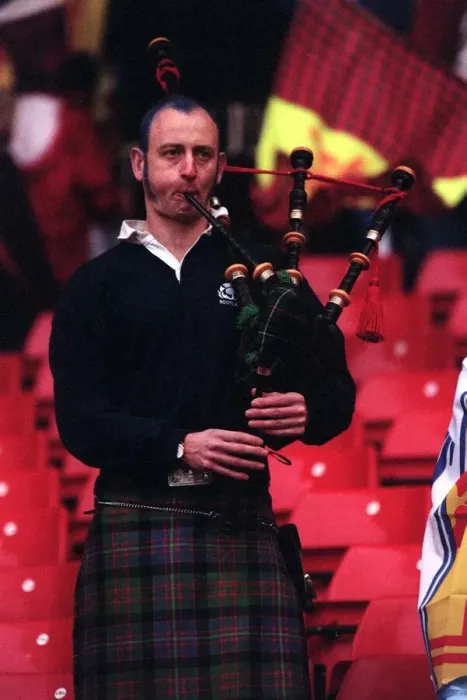 Framed Print : A Scottish fan plays the bagpipes at the end of the Scotland v England match which Framed Print : A Scottish fan plays the bagpipes at the end of the Scotland v England match which