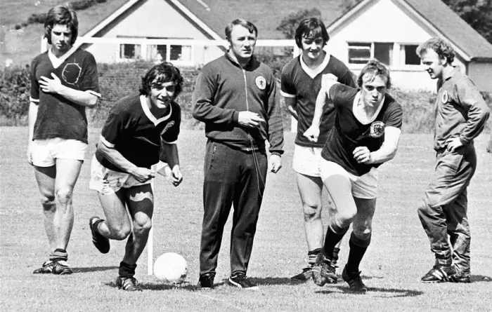 Framed Print : Scottish footballers Lou Macari and Colin Stein race each other as team boss Tommy Framed Print : Scottish footballers Lou Macari and Colin Stein race each other as team boss Tommy