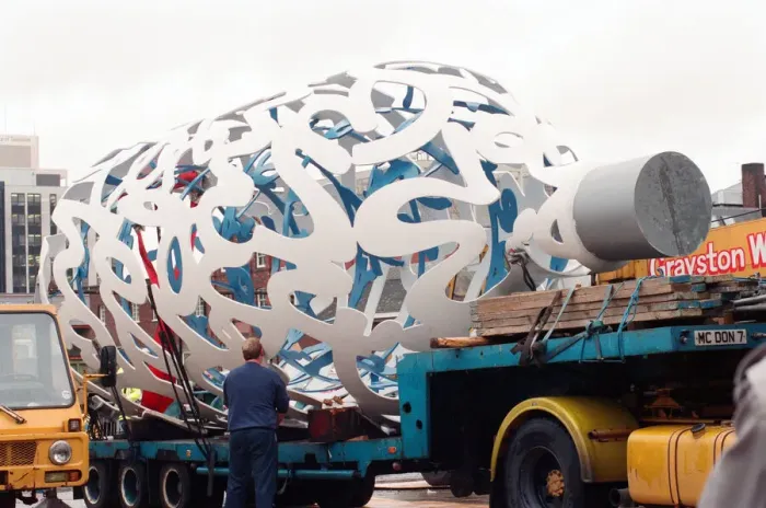 Framed Print : The sculpture Bottle of Notes is lifted off its low loader in the Central