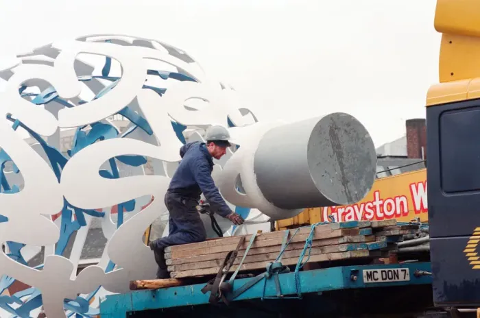 Framed Print : The sculpture Bottle of Notes is lifted off its low loader in the Central