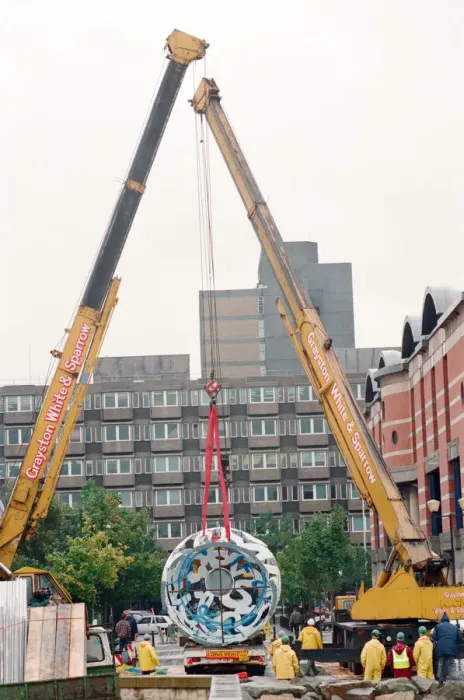 Framed Print : The sculpture Bottle of Notes is lifted off its low loader in the Central Framed Print : The sculpture Bottle of Notes is lifted off its low loader in the Central