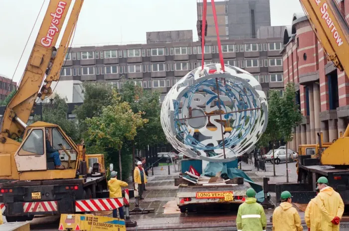 Framed Print : The sculpture Bottle of Notes is lifted off its low loader in the Central Framed Print : The sculpture Bottle of Notes is lifted off its low loader in the Central