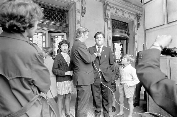 SDLP politician John Hume answers questions as he leaves the Stormont building in Belfast