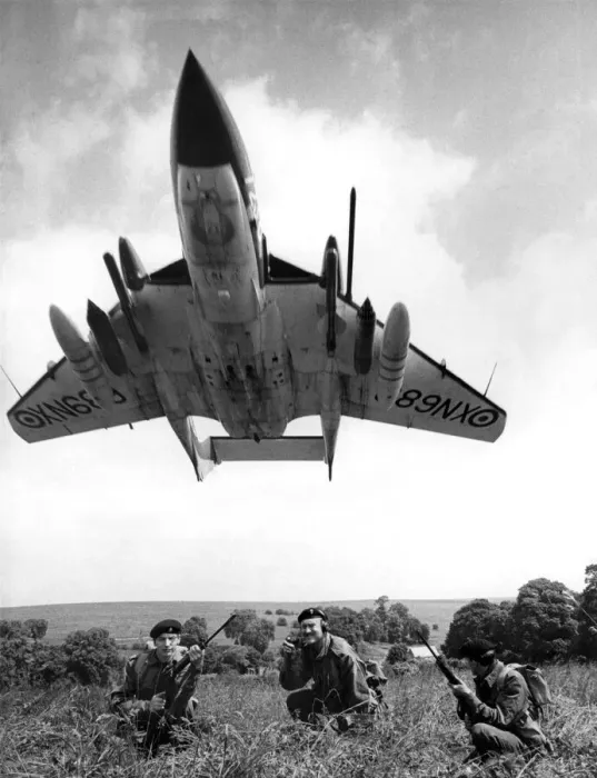 Framed Print : A Sea Vixen swoops over soldiers seen here on exercise on Salisbury Plain Framed Print : A Sea Vixen swoops over soldiers seen here on exercise on Salisbury Plain