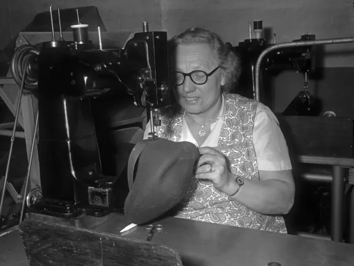 Framed Print : Seamstress sewing the inner band into a flat cap at the Denham and Hargreaves factory Framed Print : Seamstress sewing the inner band into a flat cap at the Denham and Hargreaves factory