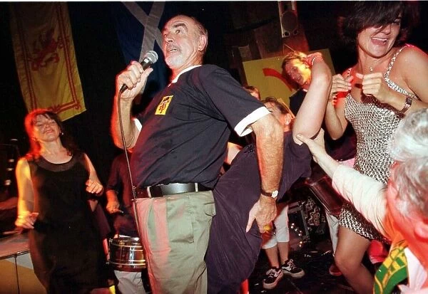 Sean Connery singing on stage with ladies June 1998