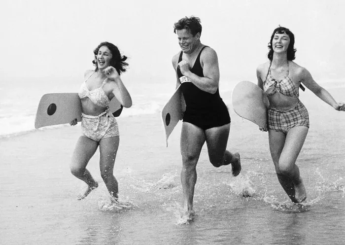Framed Print : Seaside men and women run along sea shore in swimwear Unknown date