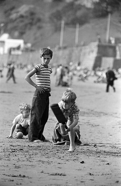 Seaside scenes in Scarborough, North Yorkshire, children playing cricket on the beach