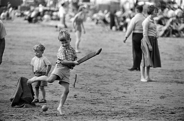 Seaside scenes in Scarborough, North Yorkshire, children playing cricket on the beach