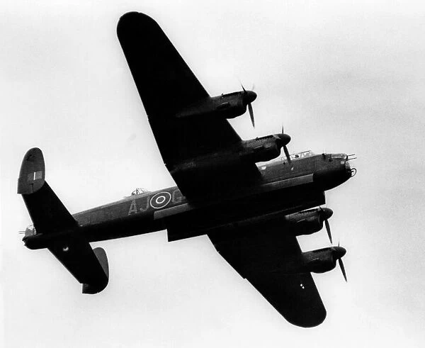 A Second World War Avro Lancaster bomber flies past at Teesside Airport. August 1981